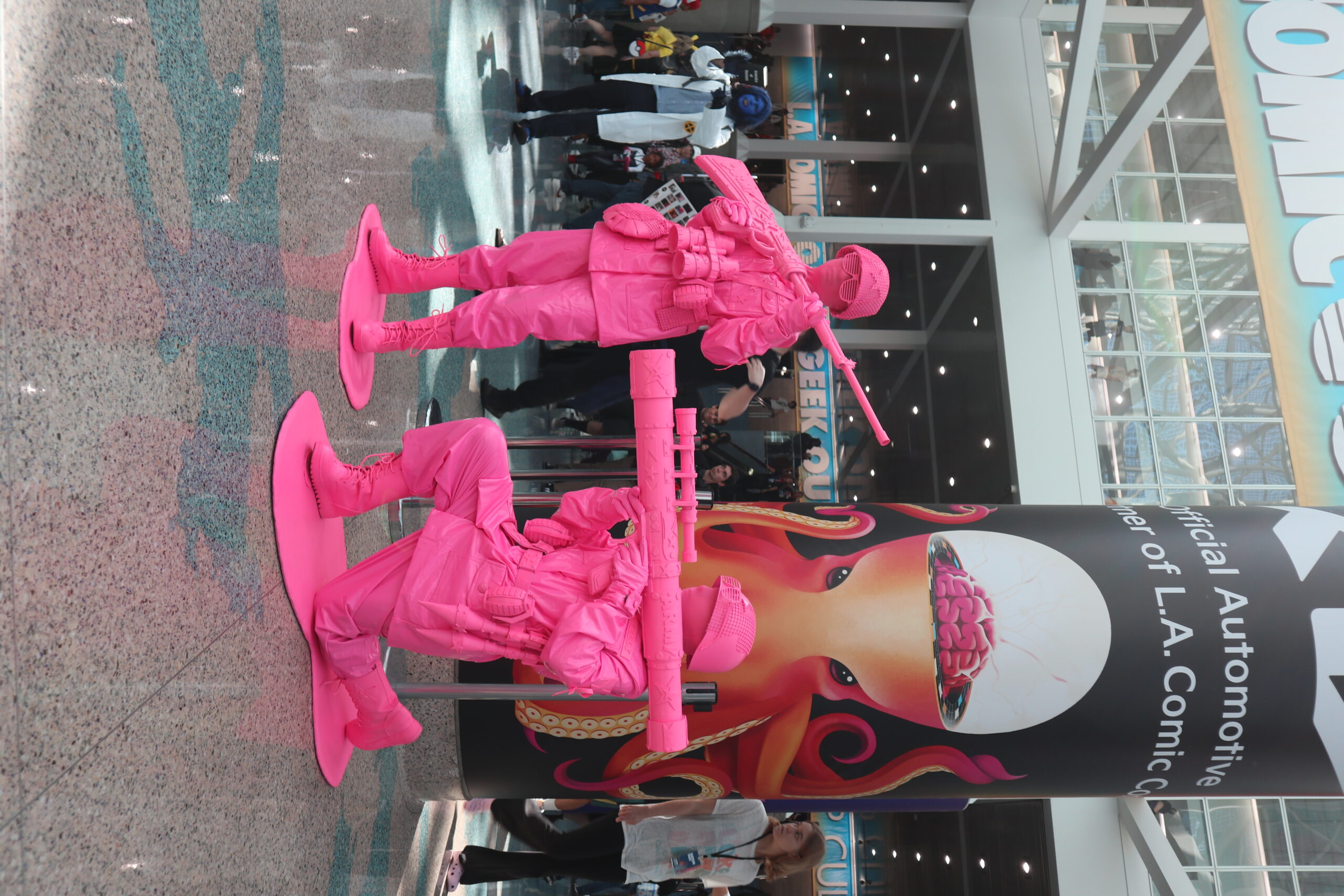 Two attendees at LA ComicCon 2024 in their pink army guy cosplay
